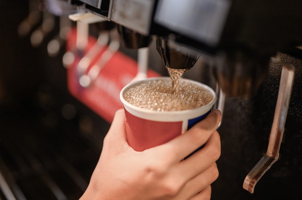 man pours a fizzy drink.sparkling water.cool ice soft drink cola